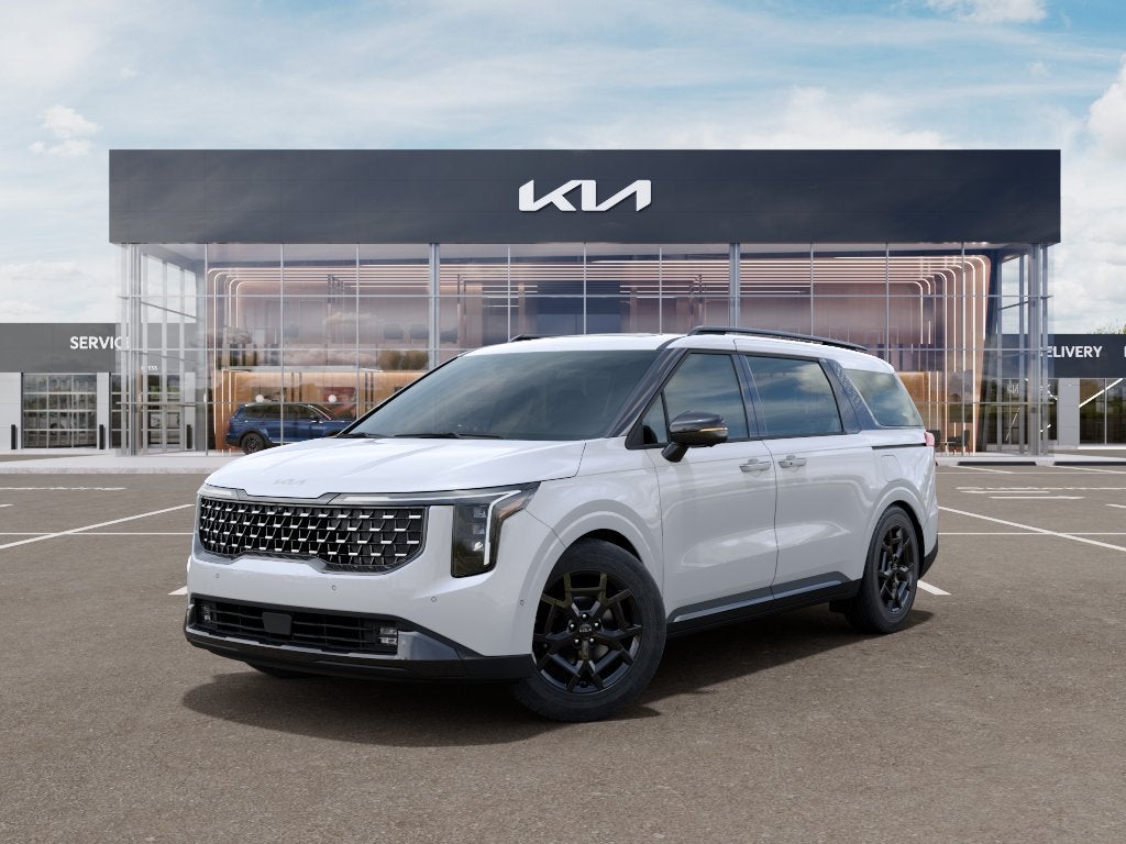 2026 Kia Carnival SX in Snow White Pearl — front three-quarter view